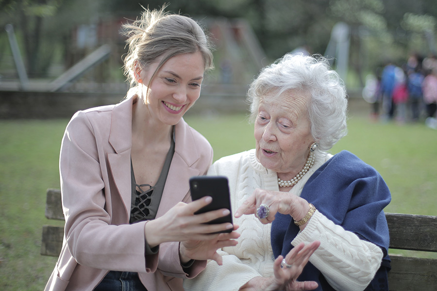 Young and older woman looking at cellphone mobile-friendly SEO